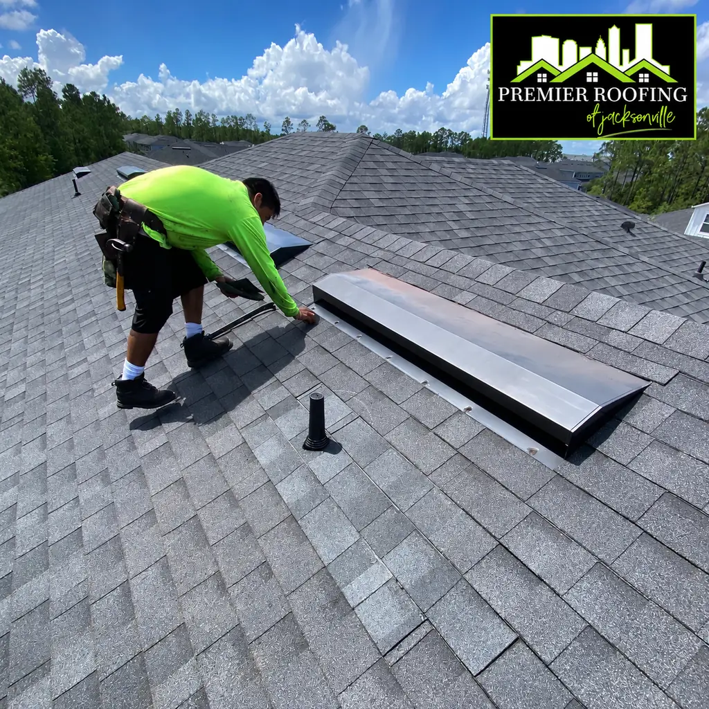 Premier Roofing crew member working on roof vent flashing during a roof tune-up