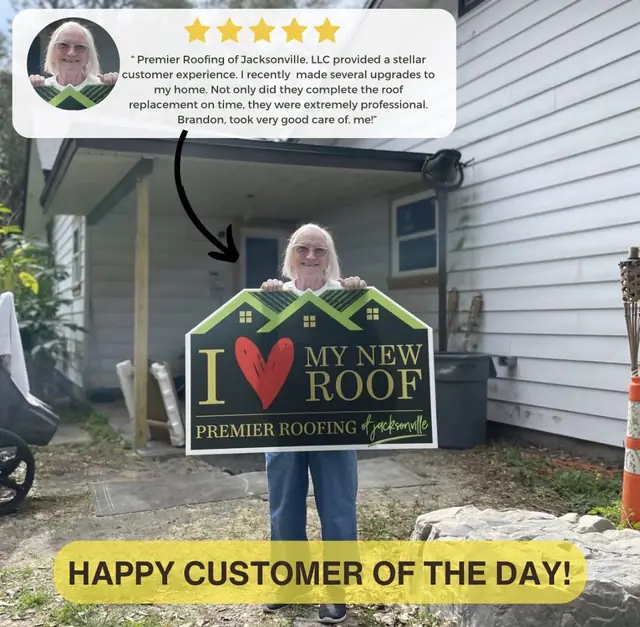 Happy customer holding a Premier Roofing new roof sign