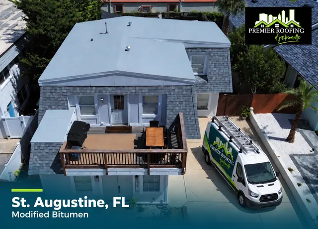 Modified bitumen roof in St. Augustine, Florida with a Premier Roofing van in the driveway